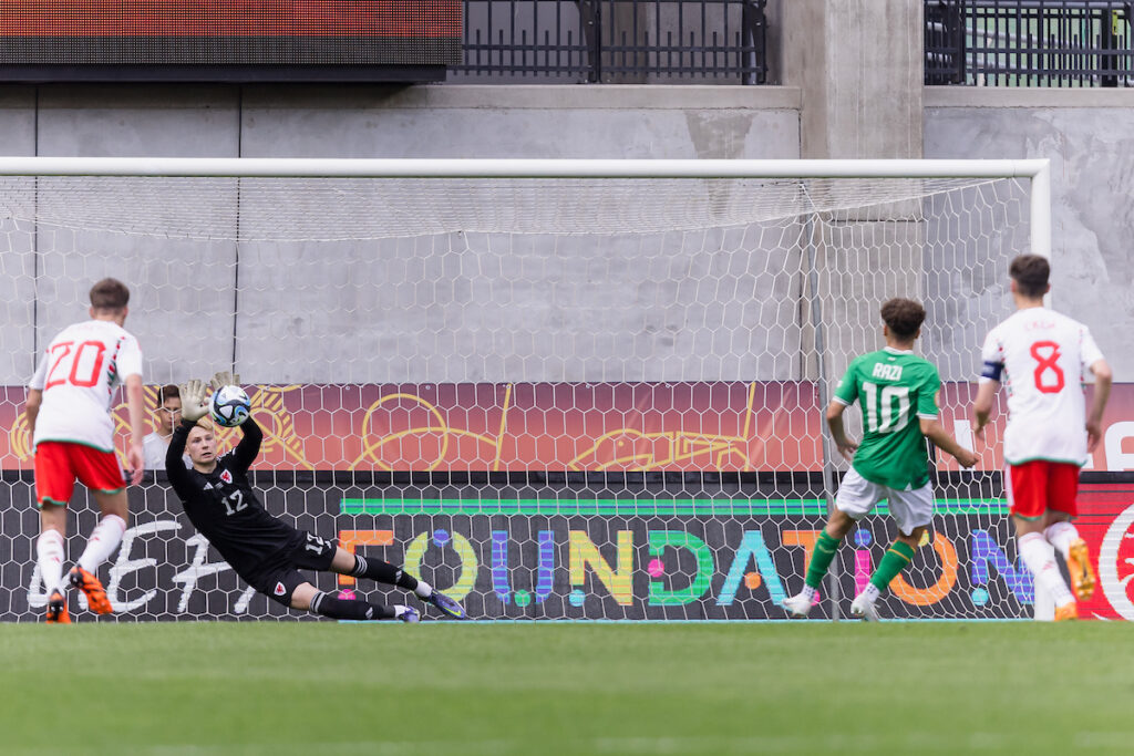 Wales' goalkeeper Luke Armstrong saves a Republic of Ireland's Najemedine Razi penalty but the referee orders him to take it again as Luke was off the line prior to the 2023 UEFA Under-17 European Championship Group A fixture between Republic of Ireland & Wales at the Pancho Aréna, Felcsút, Hungary