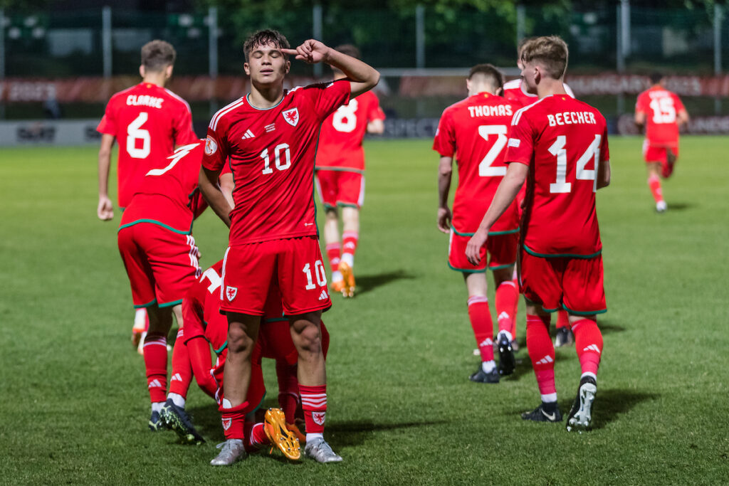 Wales' Gabriele Biancheri scores and celebrates during the 2023 UEFA European Under-17 Championship Group A fixture between Cymru & Poland at the Budaörsi Városi Stadion, Budaörs, Hungary