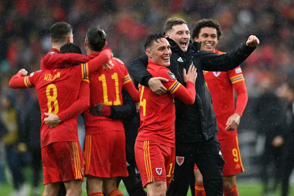 Wales' David Brooks and team mate Connor Roberts celebrate at full time during the 2022 FIFA World Cup play-off final between Wales & Ukraine at the Cardiff City Stadium on the 5th of June 2022