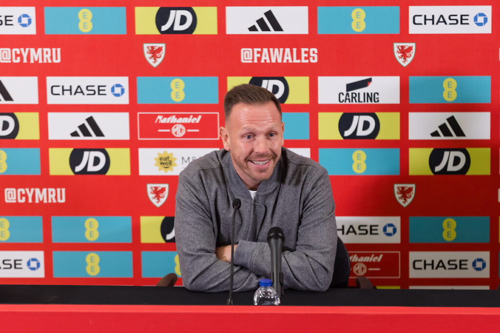 Picture of Craig Bellamy speaking at the press conference for his squad announcement.