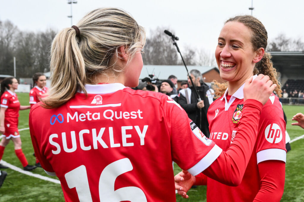 Wrexham AFC Womens' Abbie Iddenden and Ava Suckley celebrate there sides victory at the end of the 2024/25 Bute Energy Welsh Cup quarter final fixture between Wrexham Women v Swansea Women at The Rock, Wrexham, Wales