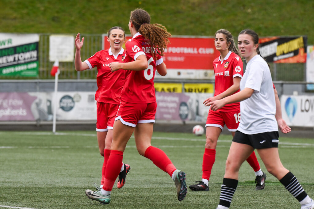 Wrexham AFC Womens' Brooke Cairns celebrates her goal to make it 3-0 during the Bute Energy Welsh Cup 2024/25 Semi-Final fixture between Wrexham Women v Pontypridd United Women at Latham Park, Newtown, Wales