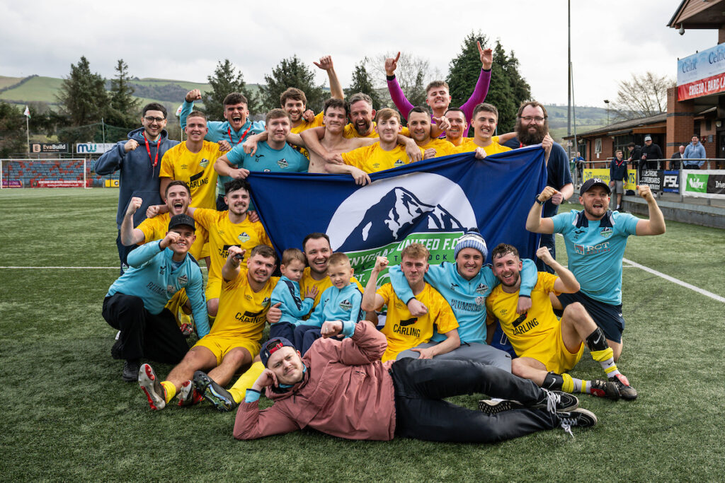 Penygraig United players celebrate winning the Dragon Signs Amateur Trophy 2024/25 Semi-Final fixture between Penygraig United v Llanrwst United at Latham Park, Newtown, Wales