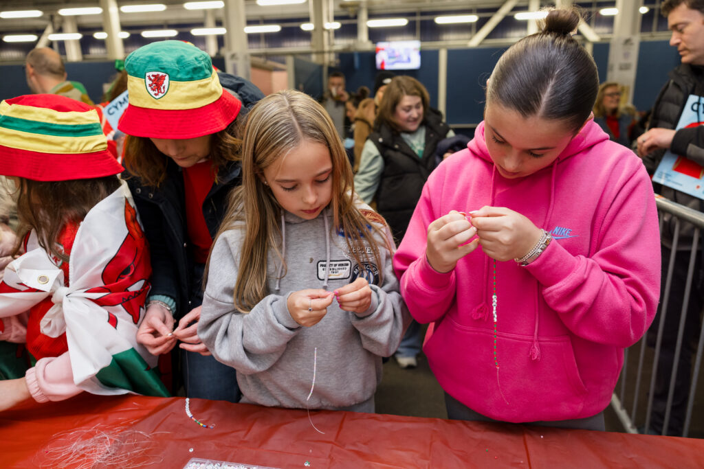 Young female Cymru supporters take part in activities prior to a match at the Cardiff City Stadium