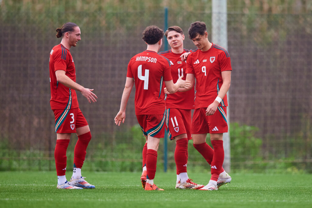 Cymru Under-21 players celebrate scoring a goal