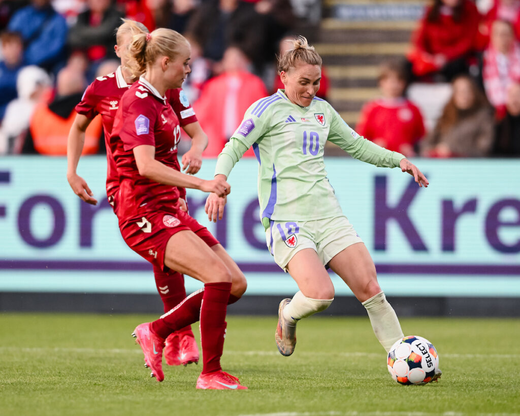 Jess Fishlock in possession of the ball as Denmark's Cornelia Kramer gets ready to challenge. 