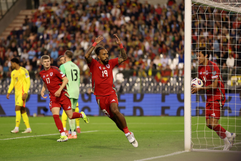 Sorba Thomas celebrates after scoring for Cymru against Belgium in a FIFA World Cup qualifier