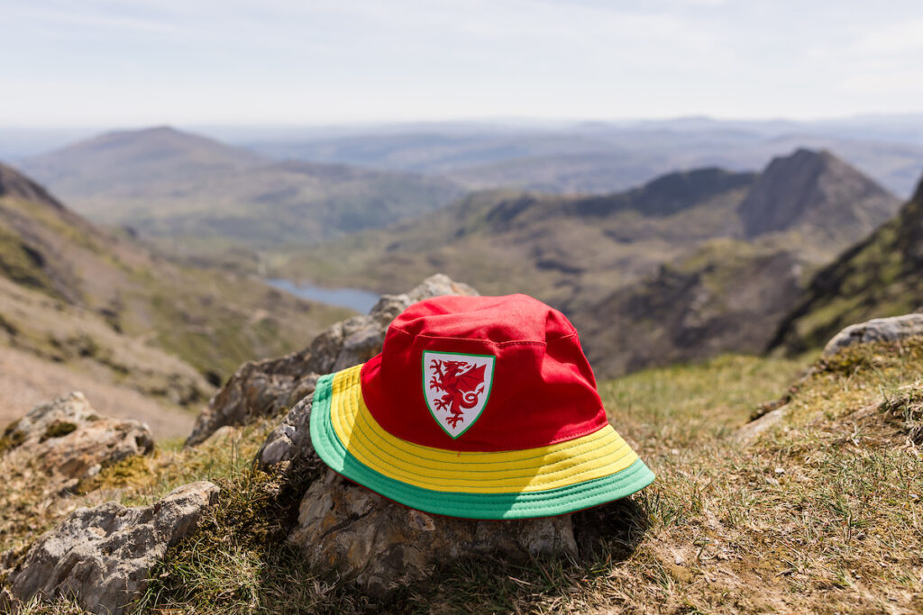 A Cymru bucket hat on top of Yr Wyddfa