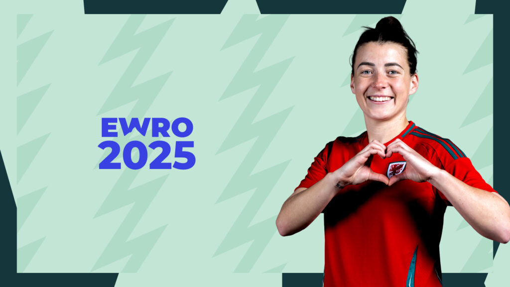 Cymru captain Angharad James uses both of her hands to make a heart gesture on the Wales badge