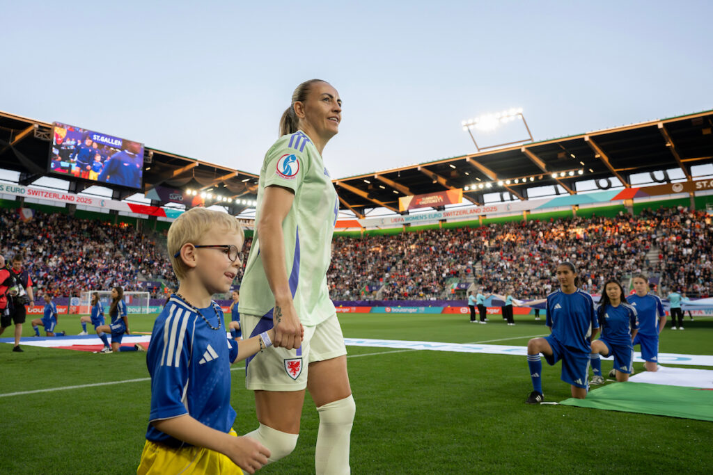 Kayleigh Barton walks onto the pitch ahead Cymru's match against France at EURO 2025.