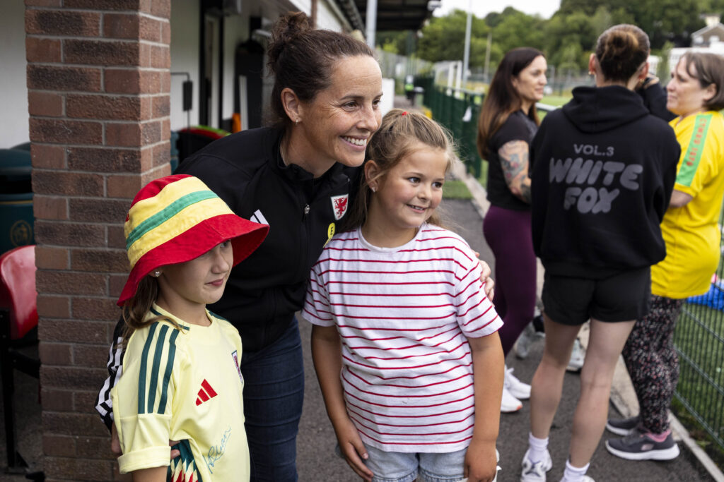 Cymru's Rhian Wilkinson poses for a photo with young supporters at Penydarren BGC