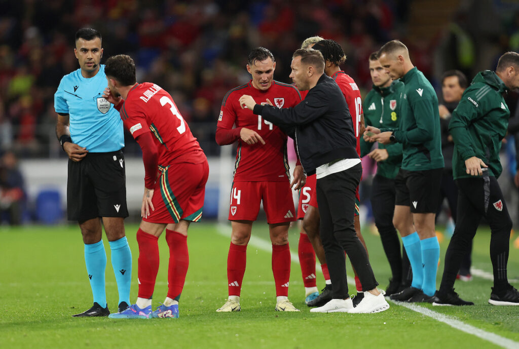 Wales’ National Team Manager Craig Bellamy speaks with Wales’ Connor Roberts during the Group H 2025 UEFA Nations League fixture between Wales & Turkey at the Cardiff City Stadium, Cardiff on the 6th of September 2024