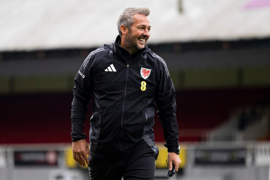 Cymru U21 manager Matty Jones smiling during a training session at Newport County's Rodney Parade. 