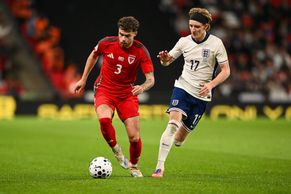 Neco Williams and Anthony Gordon battle for the ball at Wembley Stadium where England and Wales played an international friendly.