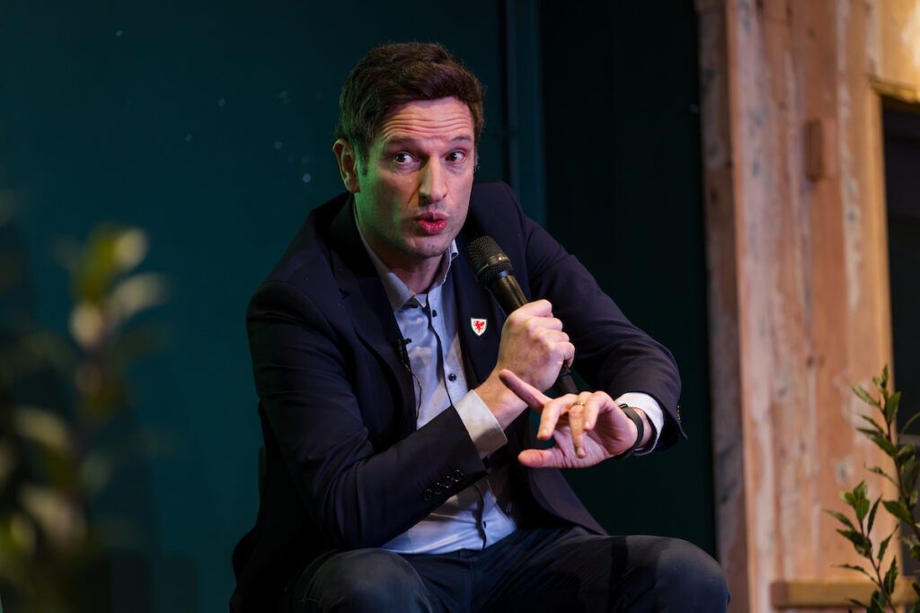 Football Association of Wales Chief Executive pictured at an event speaking to football fans in Wales.