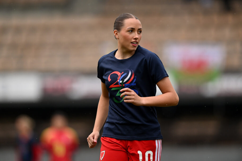 Mared Griffiths warms-up for Cymru in a FIFA Women's World Cup 2036 bid t-shirt. 